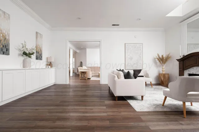 a large kitchen with stainless steel appliances kitchen island a large counter top a stove and a refrigerator