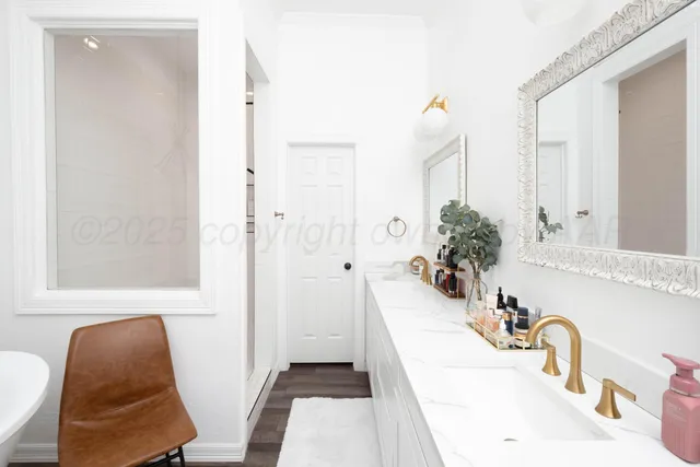 a bedroom with furniture and a large window