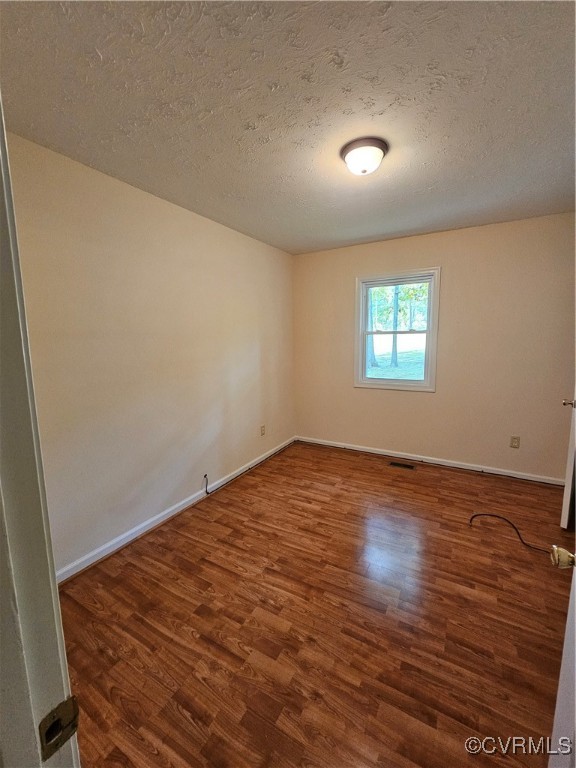 4488 Shannon Hill Road Columbia, VA 23038 - Photo 11 of 22 an empty room with wooden floor and windows
