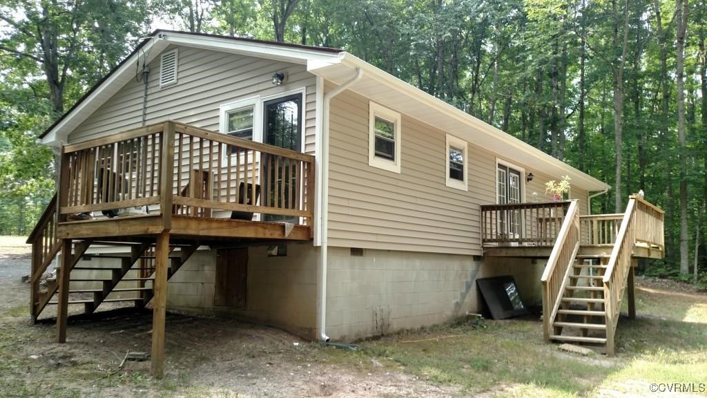 4488 Shannon Hill Road Columbia, VA 23038 - Photo 18 of 22 a view of a house with backyard and deck