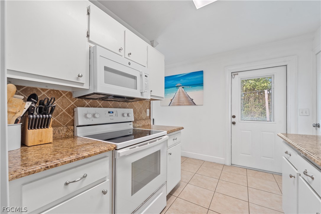 939 Bluebird Street Naples, FL 34104 - Photo 11 of 29 a kitchen with cabinets and appliances