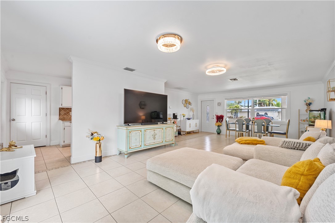 939 Bluebird Street Naples, FL 34104 - Photo 13 of 29 a living room with furniture and a flat screen tv