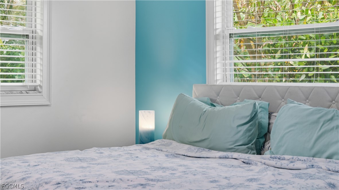 939 Bluebird Street Naples, FL 34104 - Photo 16 of 29 a bedroom with a bed and a window