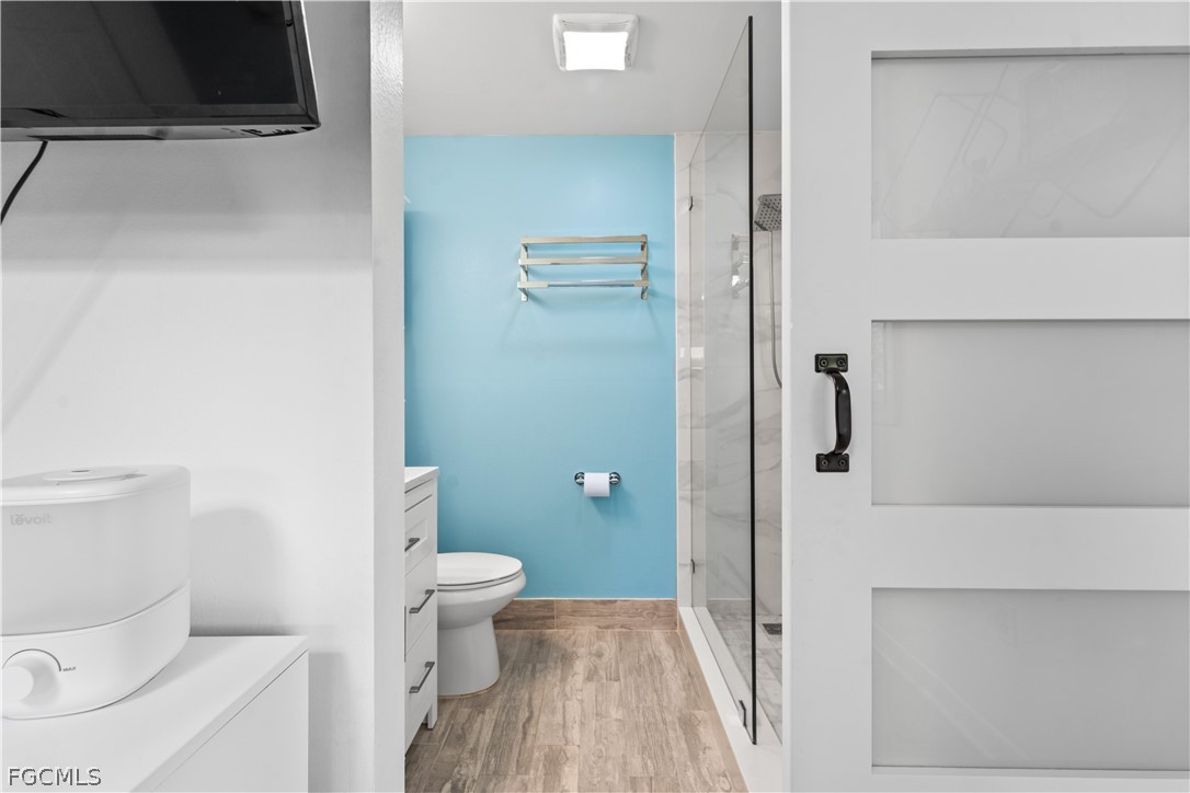 939 Bluebird Street Naples, FL 34104 - Photo 17 of 29 a bathroom with a toilet and a shower