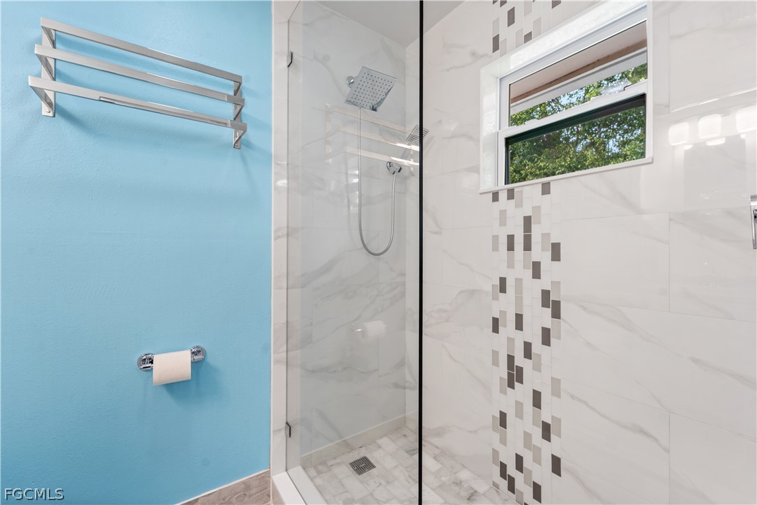 939 Bluebird Street Naples, FL 34104 - Photo 18 of 29 a bathroom with a shower