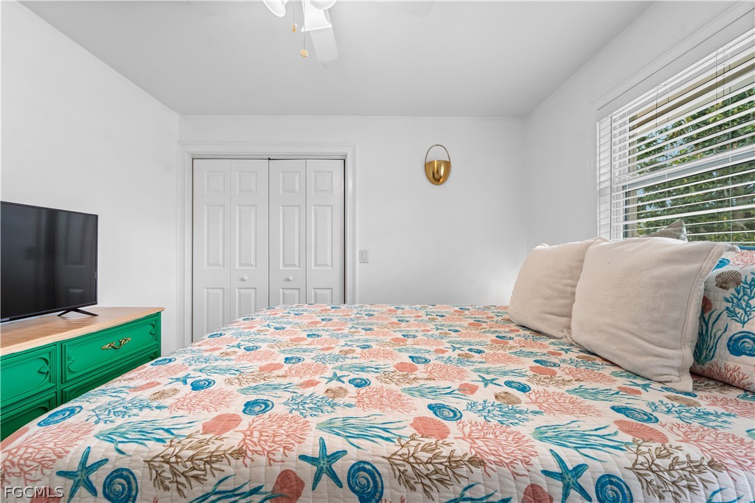 939 Bluebird Street Naples, FL 34104 - Photo 21 of 29 a bedroom with a bed and a flat screen tv