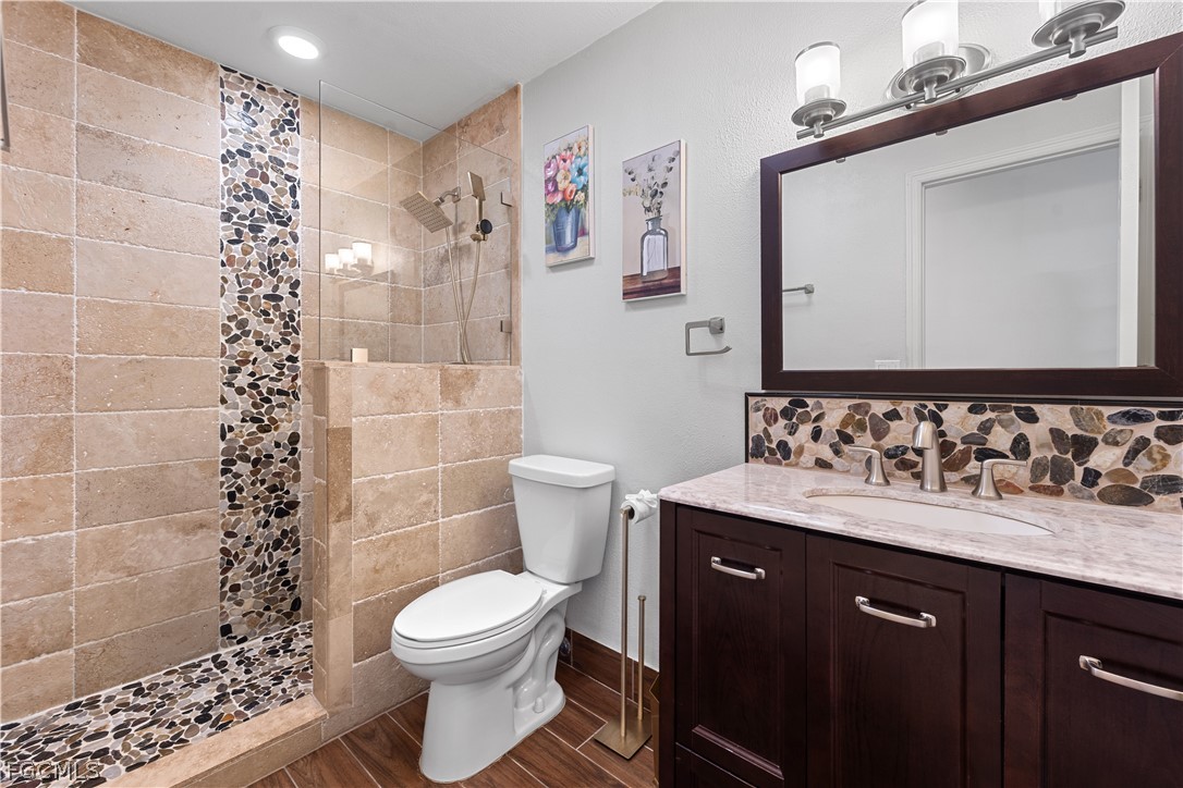 939 Bluebird Street Naples, FL 34104 - Photo 22 of 29 a bathroom with a sink a toilet and shower