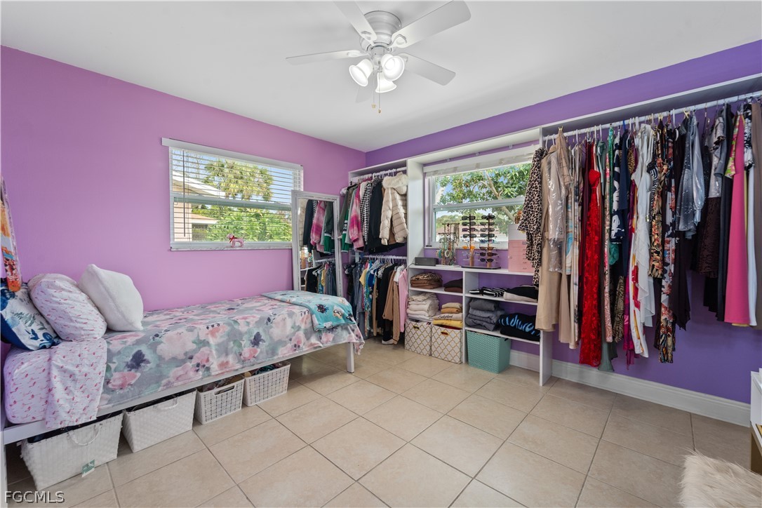 939 Bluebird Street Naples, FL 34104 - Photo 24 of 29 a bed room with a bed and a chandelier
