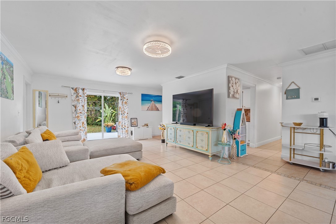 939 Bluebird Street Naples, FL 34104 - Photo 27 of 29 a living room with furniture and a flat screen tv