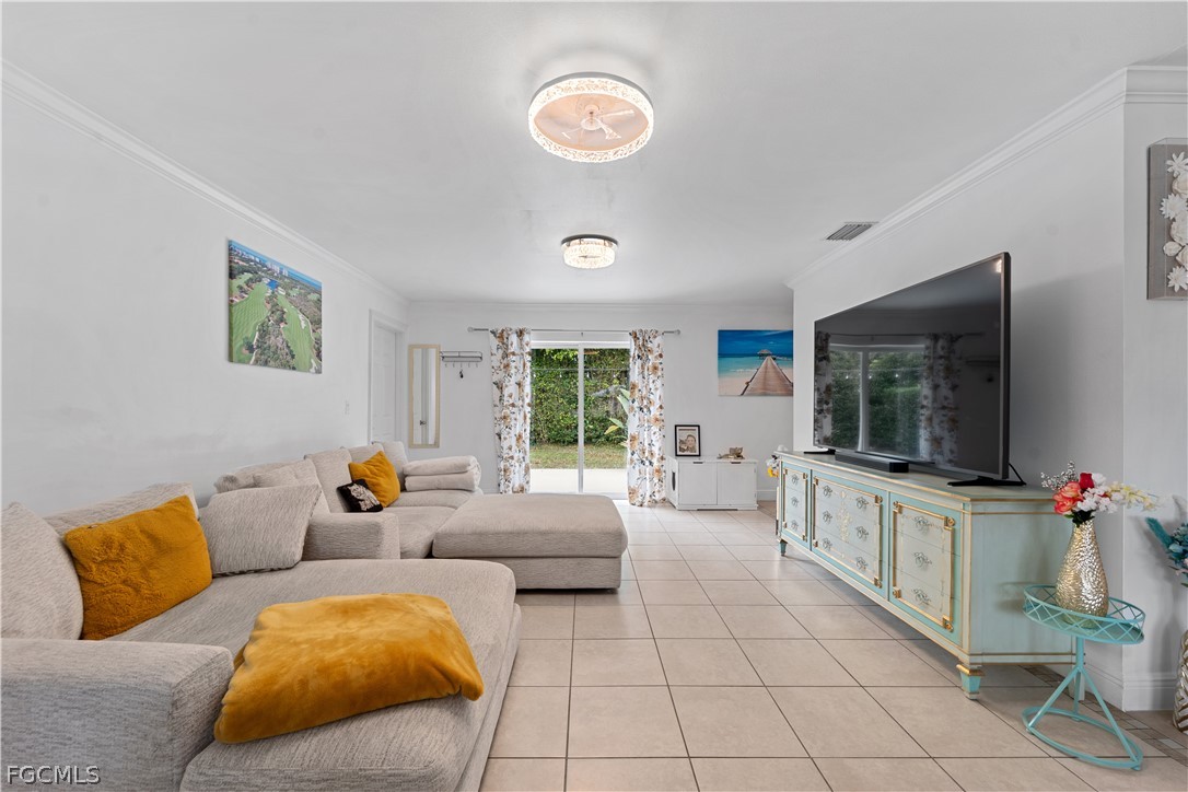 939 Bluebird Street Naples, FL 34104 - Photo 6 of 29 a living room with furniture and a flat screen tv