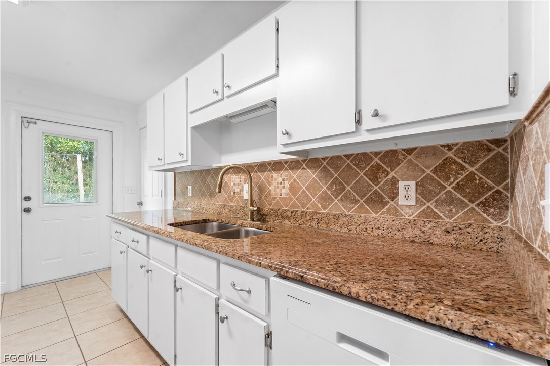 939 Bluebird Street Naples, FL 34104 - Photo 9 of 29 a kitchen with a sink and cabinets