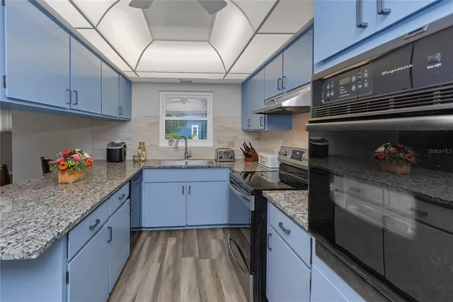 a white refrigerator freezer and a stove sitting inside of a kitchen
