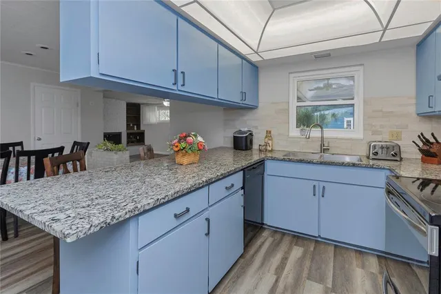 a kitchen with stainless steel appliances a refrigerator and a stove