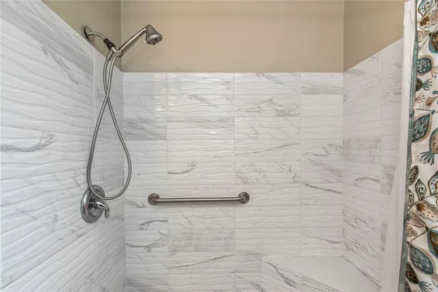 a bedroom with a bed and a ceiling fan