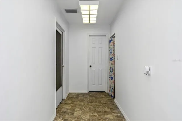 a dining room with furniture and a floor to ceiling window