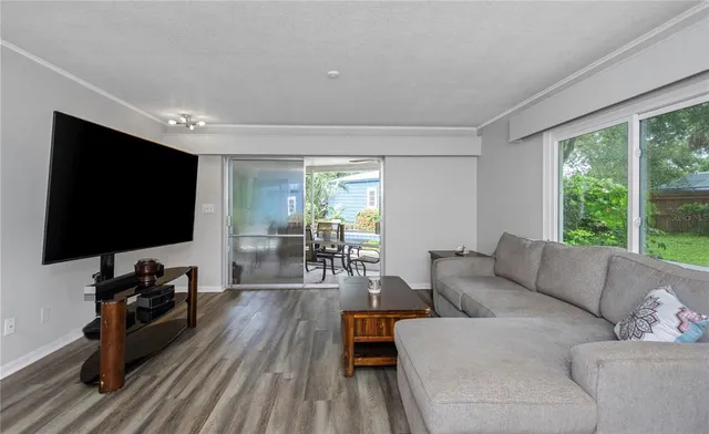 a view of a patio with table and chairs potted plants with large tree