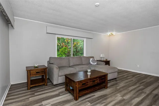 a front view of a house with a garden and trees
