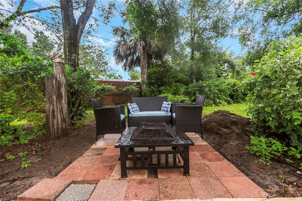 310 Terrace Drive Brandon, FL 33510 - Photo 66 of 80 a view of a patio with table and chairs potted plants with large tree