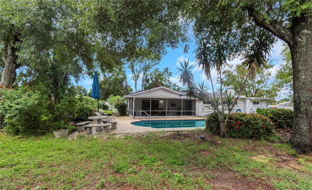 310 Terrace Drive Brandon, FL 33510 - Photo 67 of 80 a front view of a house with a garden and trees
