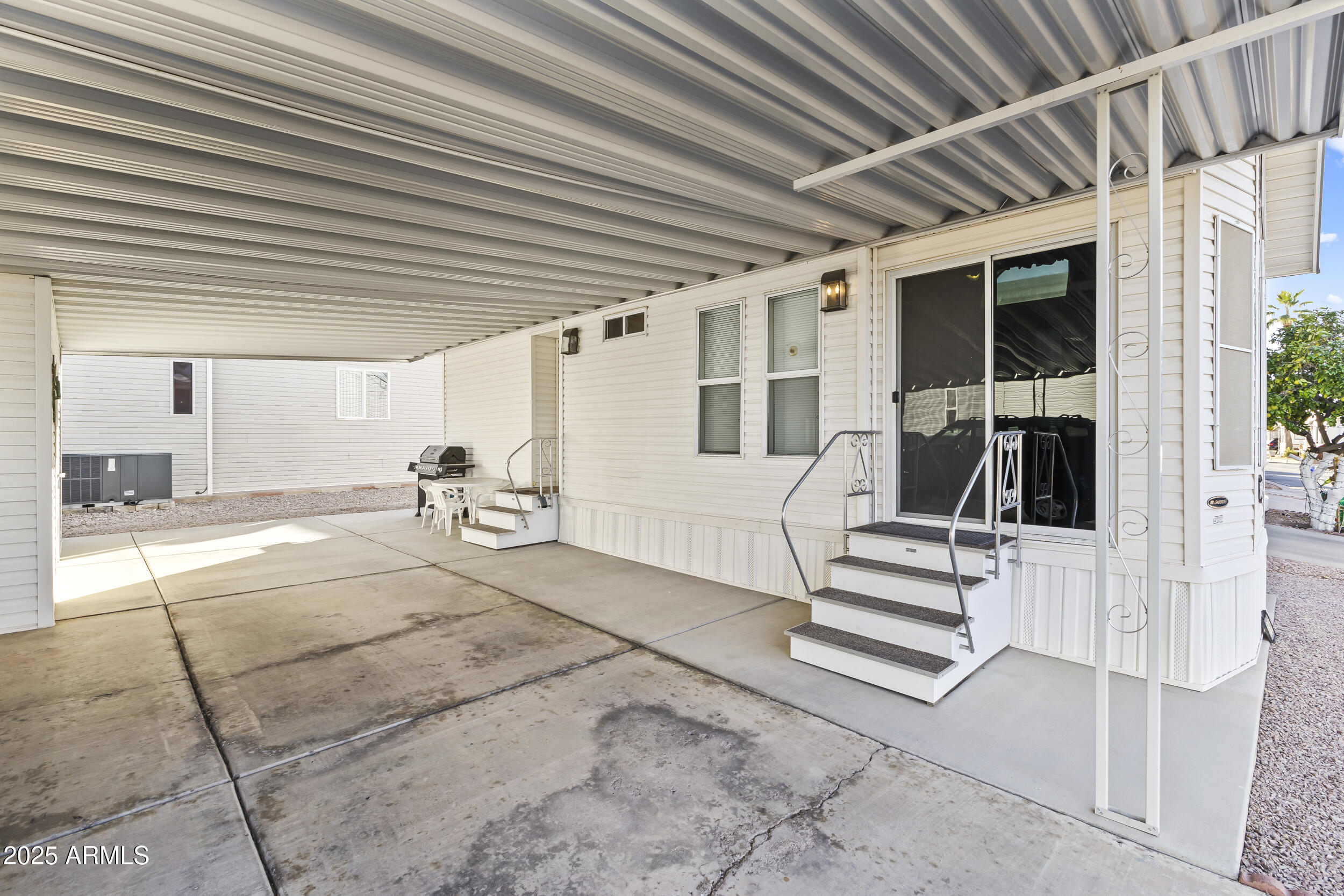 111 South Greenfield Road, Unit 238 Mesa, AZ 85206 - Photo 10 of 20 a view of a porch with wooden stairs and a table and chairs