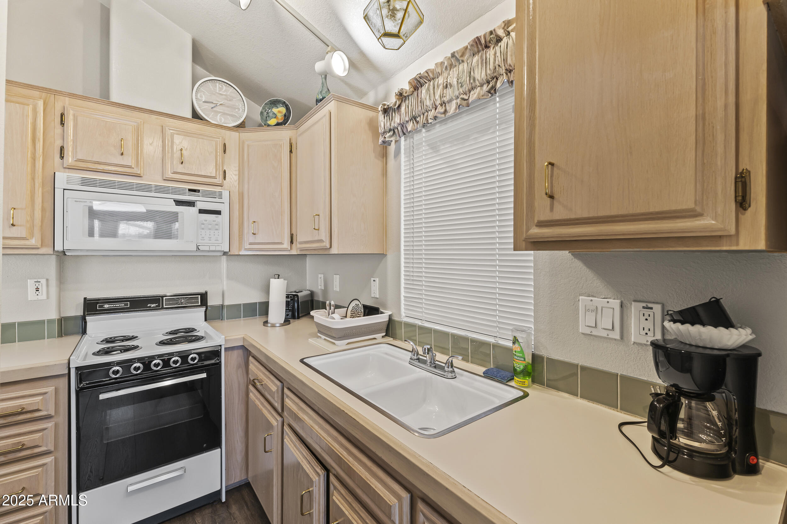 111 South Greenfield Road, Unit 238 Mesa, AZ 85206 - Photo 7 of 20 a kitchen with stainless steel appliances granite countertop a sink stove and cabinets