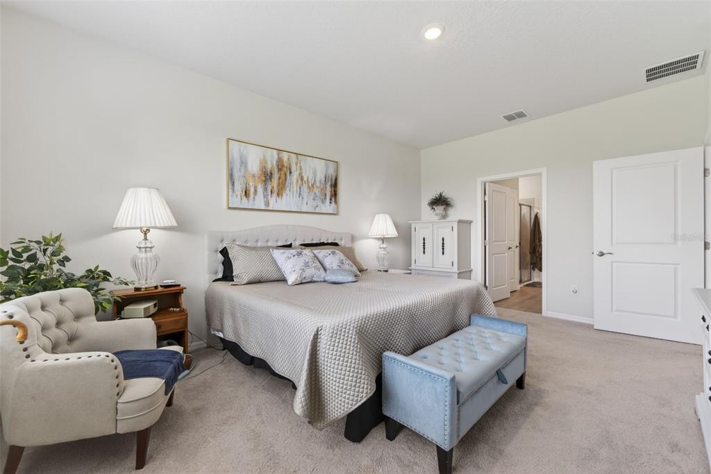 18237 Beach Ranch Terrace Bradenton, FL 34211 - Photo 42 of 72 a spacious bedroom with a bed and a couch