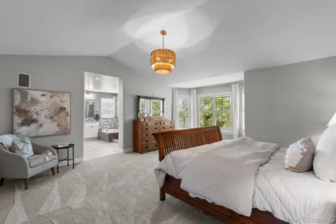 a bed room with a bed and a lamp