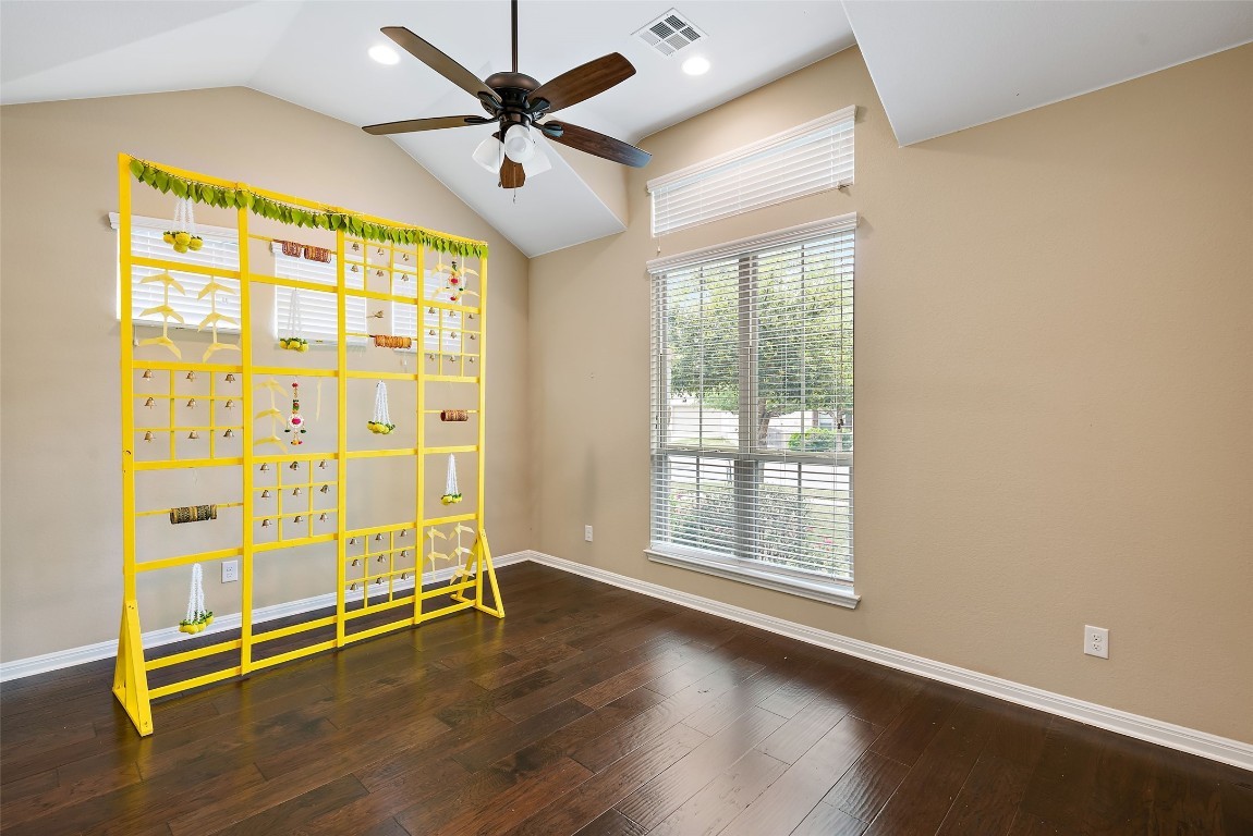 2000 Manada Trail Leander, TX 78641 - Photo 10 of 36 Hardwood floors and soaring vaulted ceilings with a ceiling fan define this versatile space.