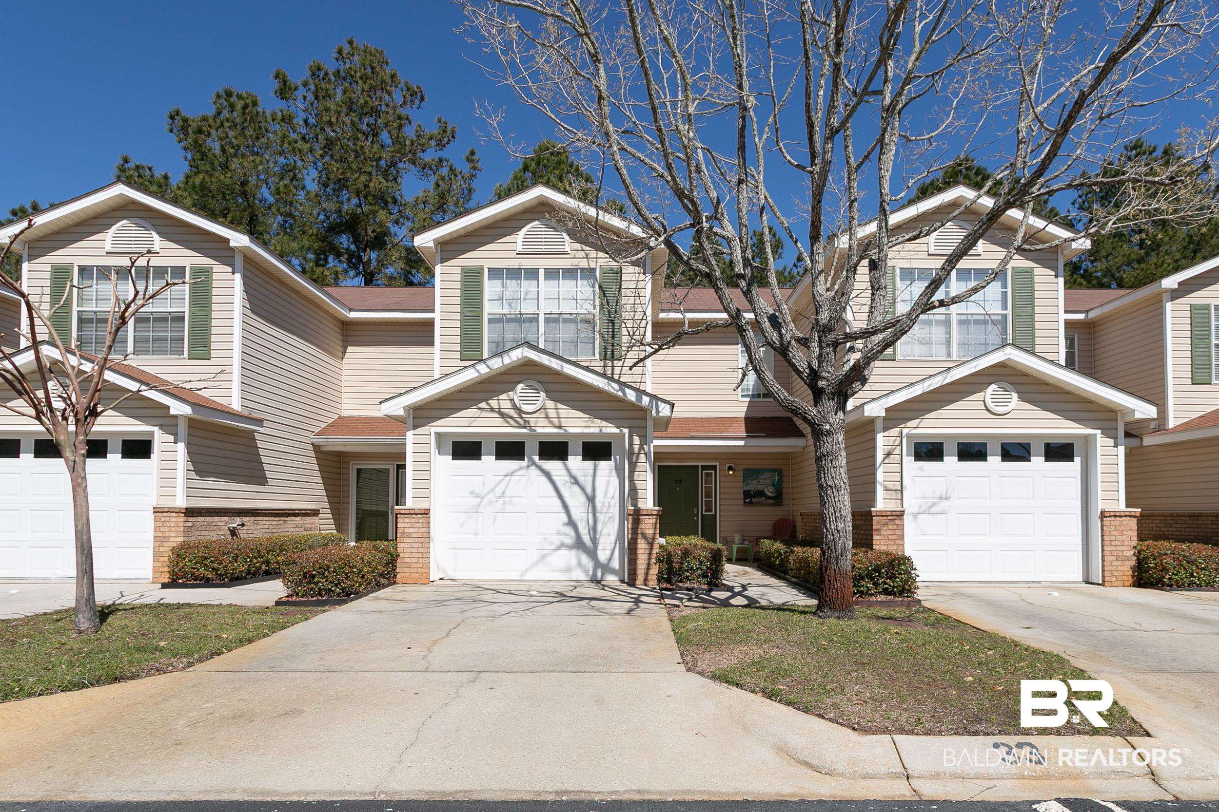 1517 Regency Road, Unit 33 Gulf Shores, AL 36542 - Photo 1 of 29 View of front of house featuring brick siding and driveway