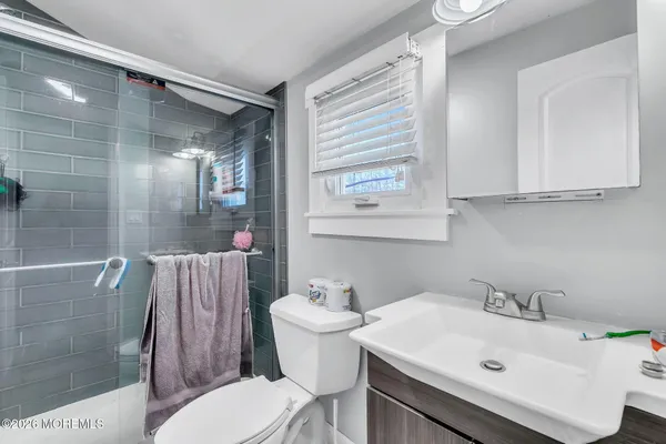 a bathroom with a sink toilet and shower