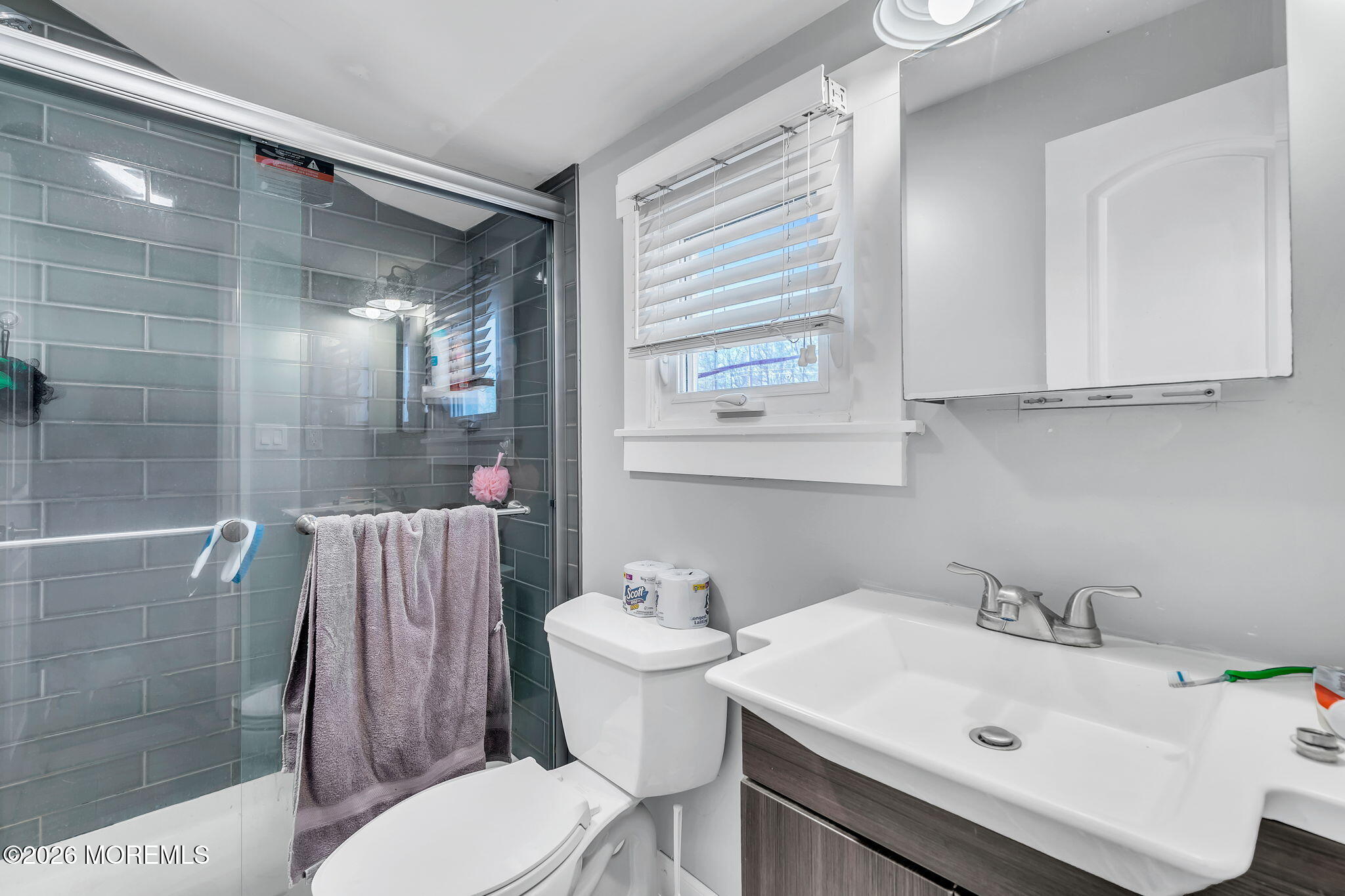 2978 Shafto Road Tinton Falls, NJ 07753 - Photo 11 of 25 a bathroom with a sink toilet and shower