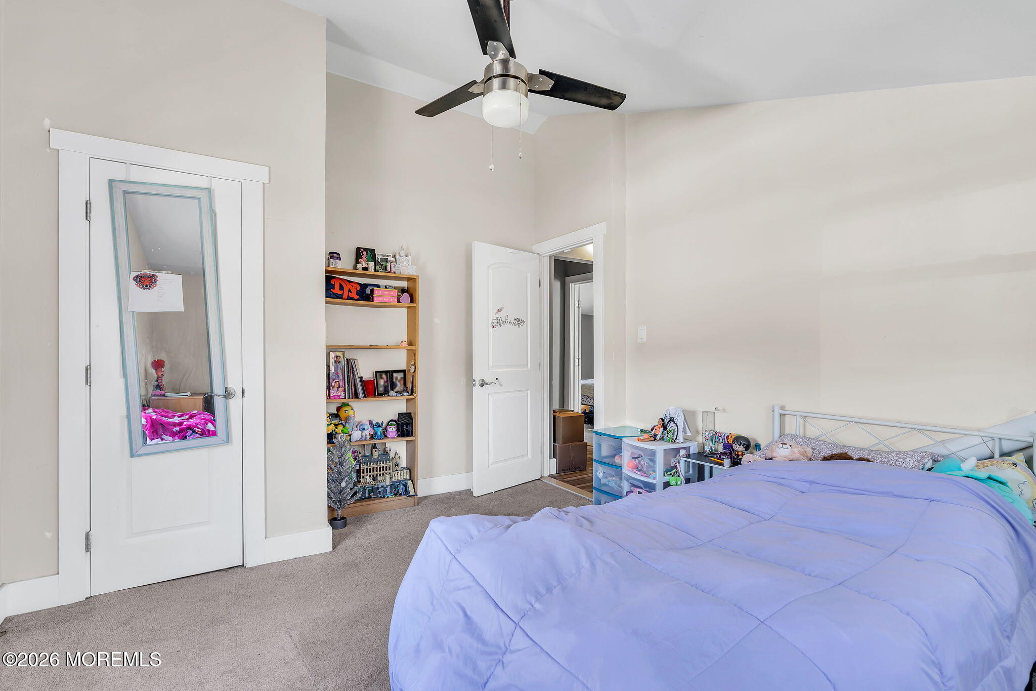 2978 Shafto Road Tinton Falls, NJ 07753 - Photo 14 of 25 a bed room with a bed and a chandelier
