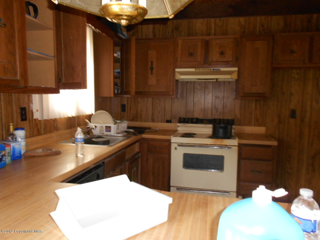 691 Decker Road Bushkill, PA 18324 - Photo 2 of 6 a kitchen with a sink stove and cabinets