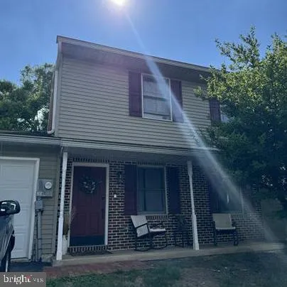 a front view of a house with plants