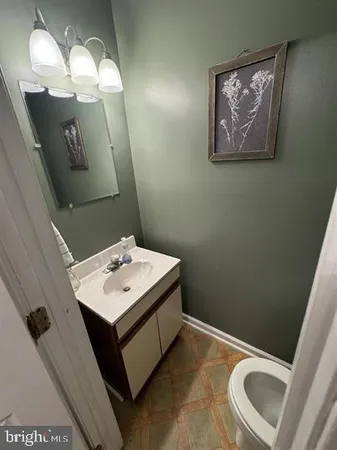 a bathroom with a sink mirror and vanity