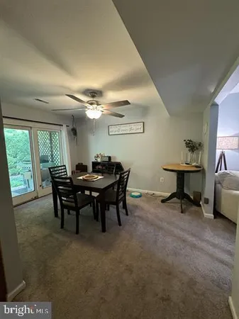 a view of a dining room with furniture and a window
