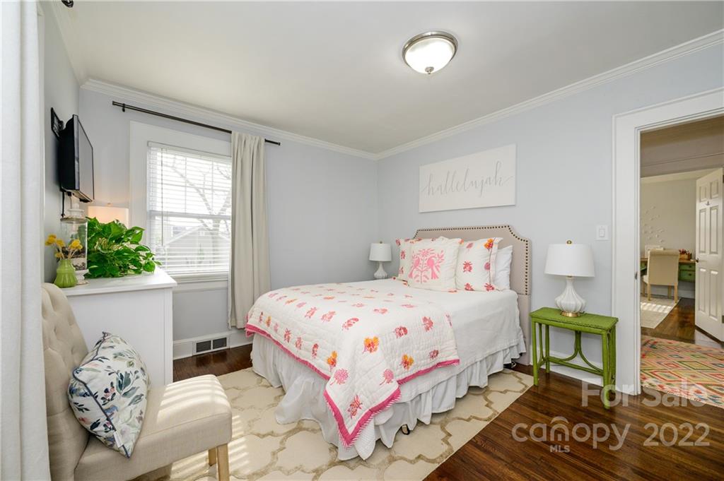 332 Marsh Road Charlotte, NC 28209 - Photo 20 of 37 a bedroom with a bed table flowerpot and window