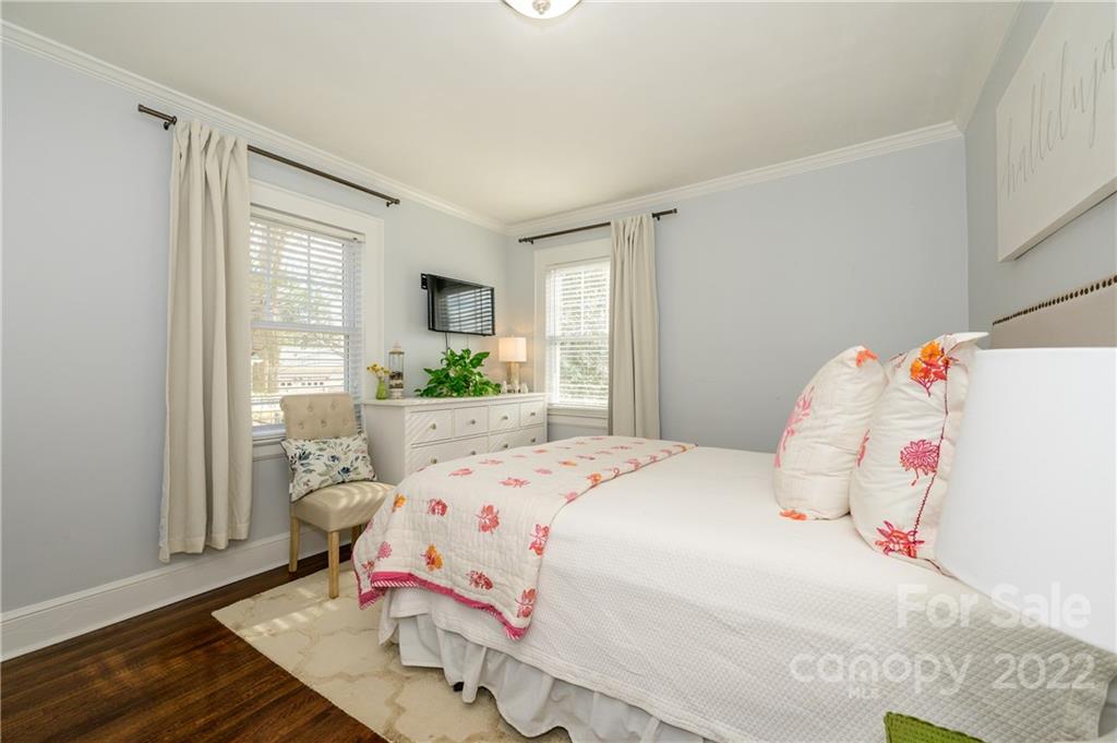332 Marsh Road Charlotte, NC 28209 - Photo 21 of 37 a bedroom with a bed and wooden floor