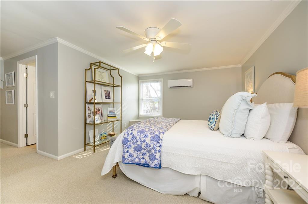 332 Marsh Road Charlotte, NC 28209 - Photo 28 of 37 a bedroom with a bed and a chandelier