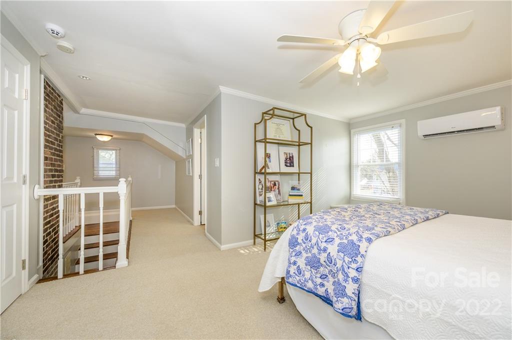 332 Marsh Road Charlotte, NC 28209 - Photo 29 of 37 a bedroom with a large bed and a chandelier