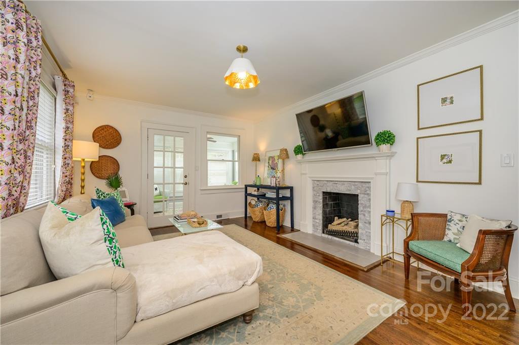 332 Marsh Road Charlotte, NC 28209 - Photo 3 of 37 a living room with furniture a flat screen tv and a fireplace