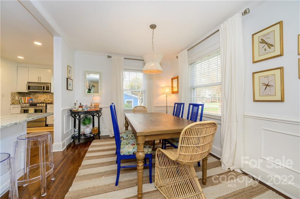 332 Marsh Road Charlotte, NC 28209 - Photo 9 of 37 a dining room with furniture a rug and wooden floor