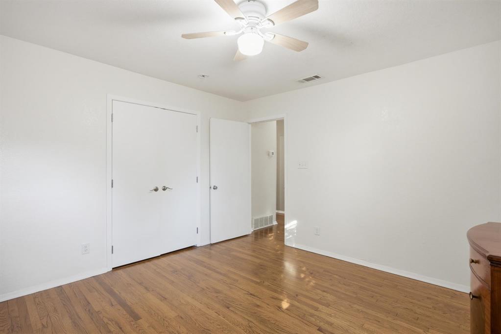 1004 Usher Street Benbrook, TX 76126 - Photo 12 of 25 a view of an empty room with wooden floor