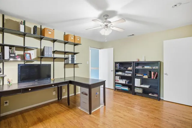 a view of a living room with furniture and wooden floor
