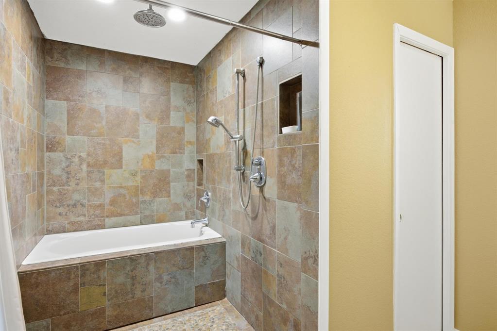 1004 Usher Street Benbrook, TX 76126 - Photo 17 of 25 a bathroom with a bathtub and shower