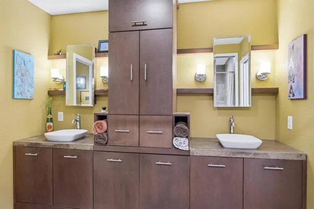 a bathroom with a sink vanity and a mirror