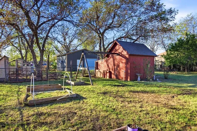 a view of a house with backyard and sitting area