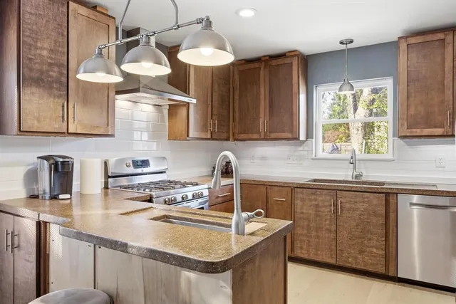 a kitchen with a sink cabinets and window