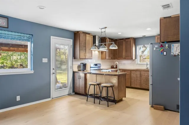 a kitchen with a refrigerator and a sink