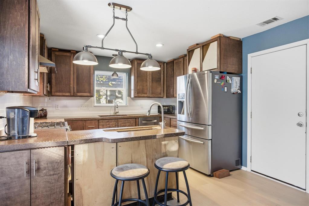 1004 Usher Street Benbrook, TX 76126 - Photo 6 of 25 a kitchen with stainless steel appliances granite countertop a refrigerator a sink a stove and island
